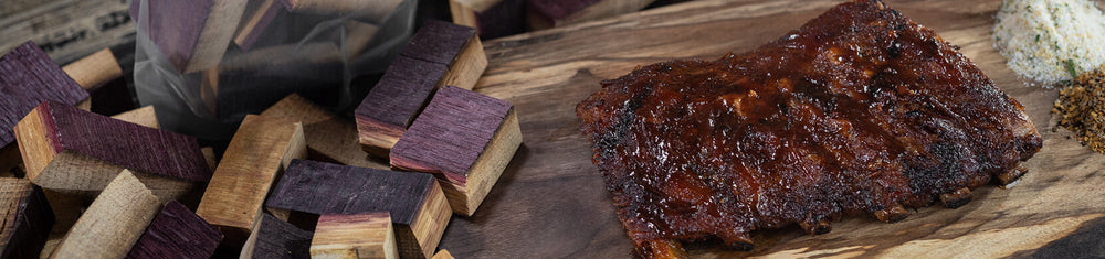 meat and red wine barrel smoking wood chunks on a wood table